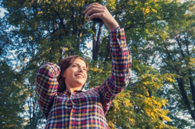 Selfie zamanı. Güzel genç kız parkta selfie çekiyor..