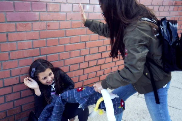 Schoolyard bullies, concept of this taking place after school,Aggressive teenagers bullying boy outdoors. - Image — Stock Photo, Image