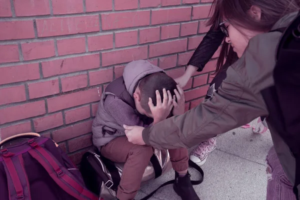 Schoolyard bullies, concept of this taking place after school,Aggressive teenagers bullying boy outdoors. - Image — Stock Photo, Image