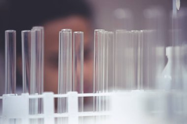 Laboratuvarda deney tüpüyle çalışan çok kültürlü bilim adamları.