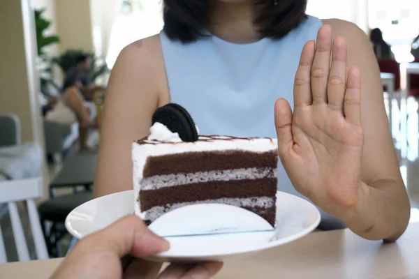 One of the health-care girls used a hand to push a plate of chocolate cake. Refuse to eat foods that contain Trans Fat.