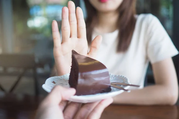 One of the health-care girls used a hand to push a plate of chocolate cake. Refuse to eat foods that contain Trans Fat.