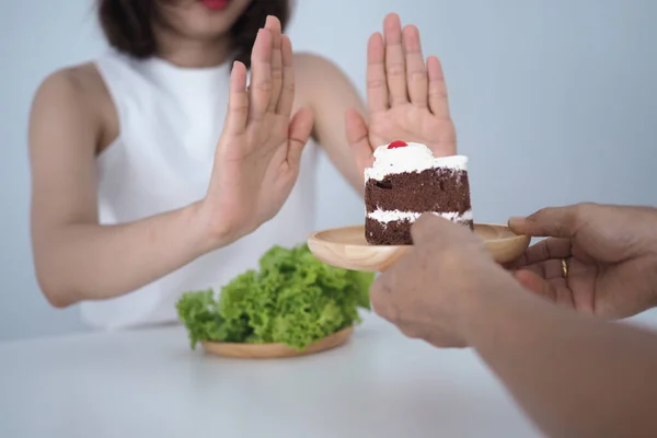 One of the health-care girls used a hand to push a plate of chocolate cake. Refuse to eat foods that contain Trans Fat.