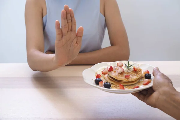 Women pushed pastry dishes. Stop eating dessert, good health