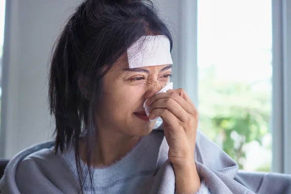 Asian women have high fever and runny nose. sick people concept