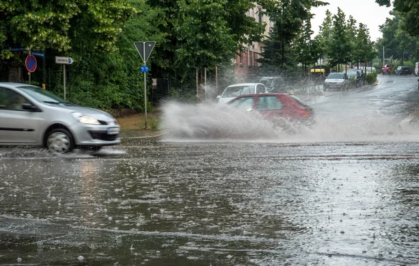 Flooded city road with rain puddles — Stockfoto
