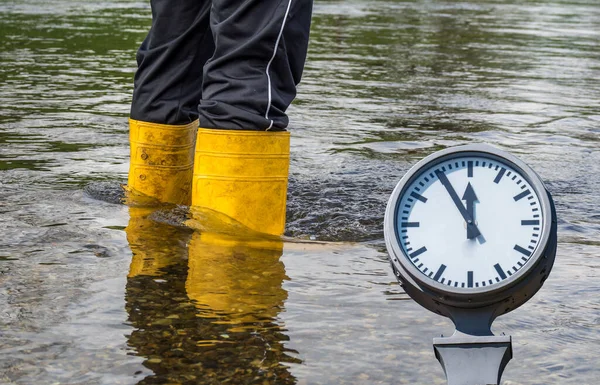 Wellies in the flood with clock — Stock fotografie