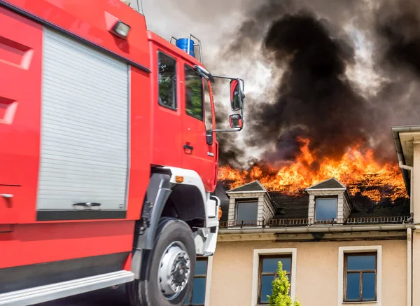 Пожарная служба с горящим домом — стоковое фото