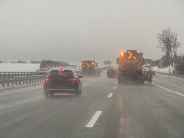 Winter road clearance on a German motorway clipart