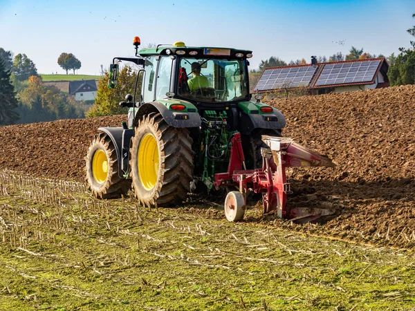 Tractor plows the field in the autumn — Stock Photo, Image