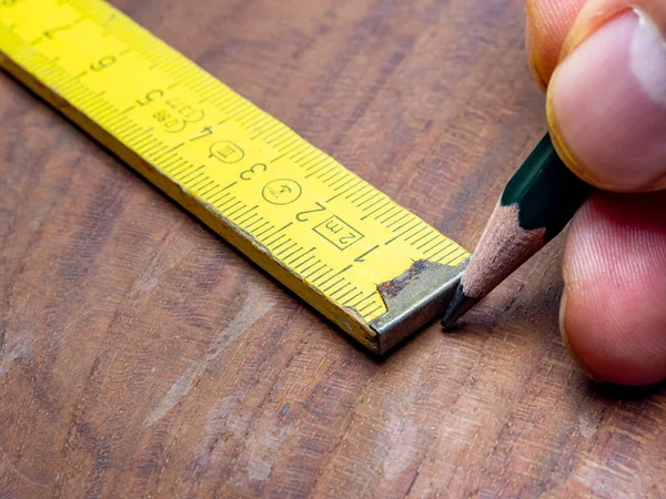 Measuring and marking with a folding rule — Stok fotoğraf