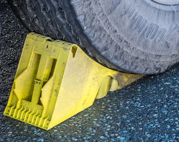 Wheel chock under a truck Wheel — Stok fotoğraf