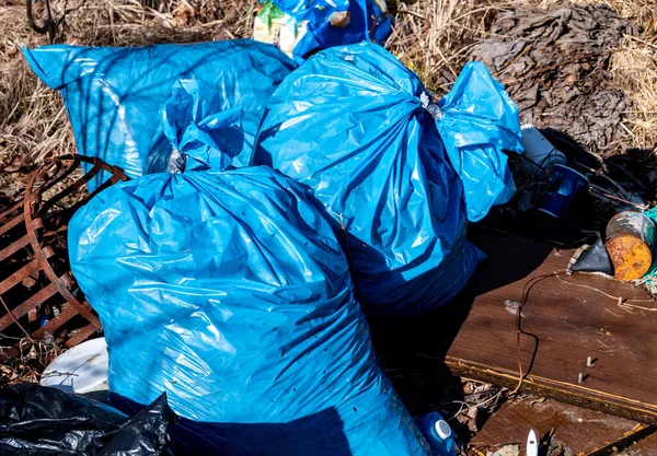 Many blue garbage bags on the recycling center