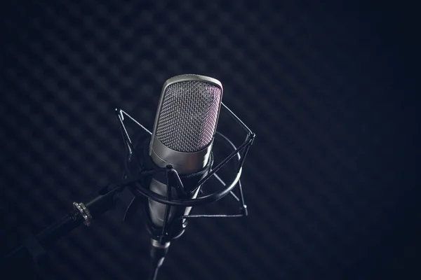 stock image Microphone and audio console on dark background