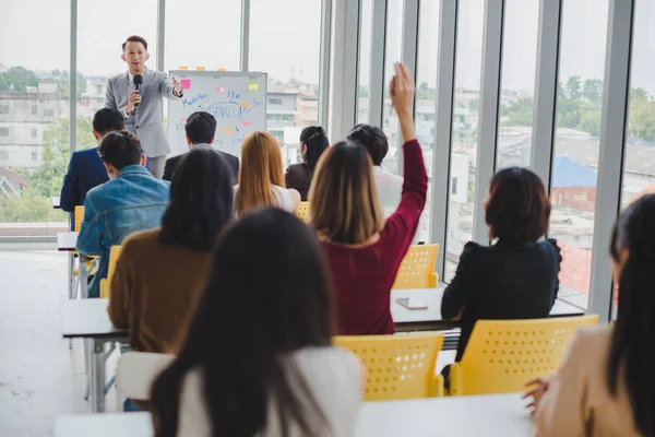 Asian male speaker is speaking at seminars and workshops to the 