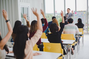 Asian male speaker is speaking at seminars and workshops to the 