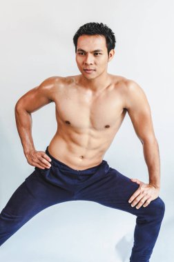 Asian young man with muscular body On the white back