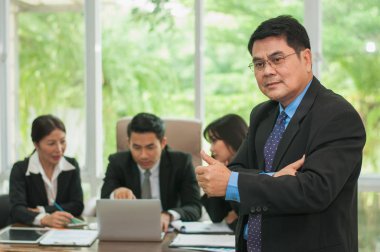 Yöneticiler ve çalışanlar iş yerinde iş konuşuyorlar.