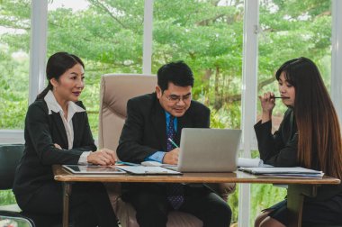 Yöneticiler ve çalışanlar iş yerinde iş konuşuyorlar.