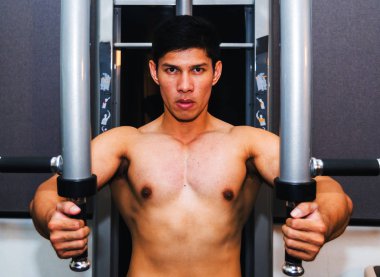 Asyalı kaslı adamlar spor salonunda ağırlık kaldırıyor..