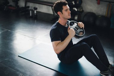 Young man caucasian was exercising by the use weight plate on yo
