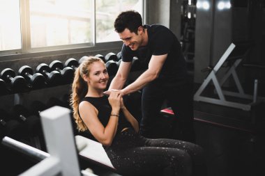 Güzel bir kadın egzersiz ve spor yapıyor. Antrenör veriyor.