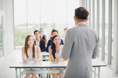 Asian male speaker is speaking at seminars and workshops to the 