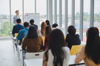 Asian male speaker is speaking at seminars and workshops to the 