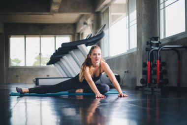 Güzel bir sporcu bir takım elbise giydi. Bir kas üzerinde gerinme
