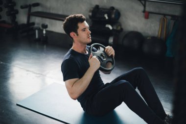 Young man caucasian was exercising by the use weight plate on yo