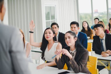 Asian male speaker is speaking at seminars and workshops to the 
