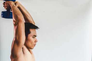 Asian young man with muscular body On the white back