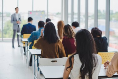 Asian male speaker is speaking at seminars and workshops to the 