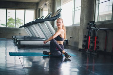 Güzel bir sporcu bir takım elbise giydi. Bir kas üzerinde gerinme
