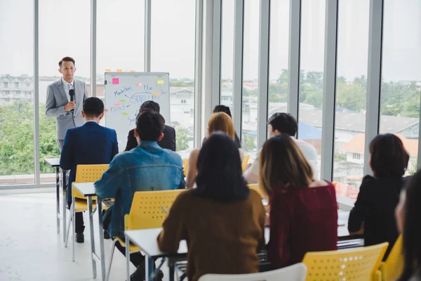 Asian male speaker is speaking at seminars and workshops to the 