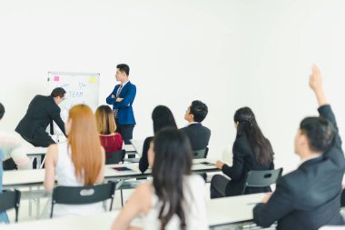 Asian male speaker is speaking at seminars and workshops to the 