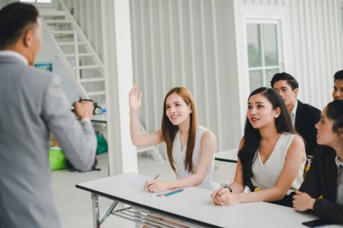 Asian male speaker is speaking at seminars and workshops to the 