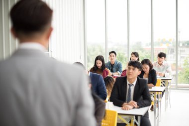 Asian male speaker is speaking at seminars and workshops to the 