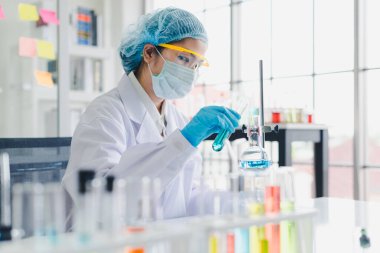 Asyalı bilim adamları laboratuvarda birçok kimyasalı test edip analiz ediyorlar. Bilim ve Kimyasal Konseptler.