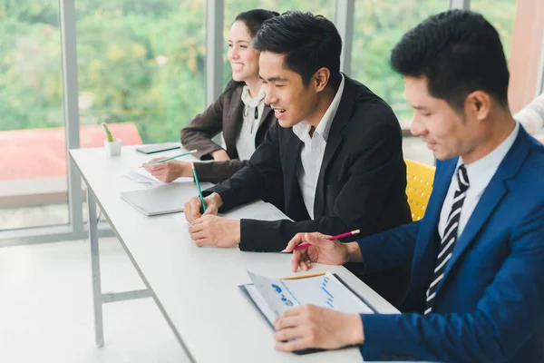 Asian male speaker is speaking at seminars and workshops to the people in the meeting.