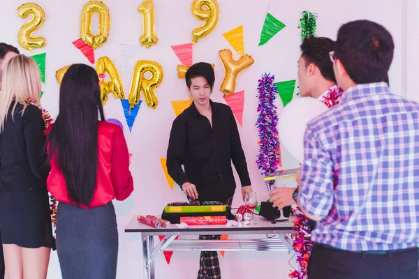 Company Employees of a party to celebrate the New Year 2019 and a DJ at parties. Concept Happy New Year.