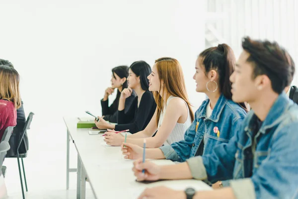 Asyalılar seminerlere katılır ve eğitim odasındaki hoparlörlerden ders dinlerler. Bazı insanlar not alır. Bazı insanlar anlatıcı sormak için ellerini kaldırdı. Ve konuşmacı konuşmasını bitirdiğinde alkışlandı..