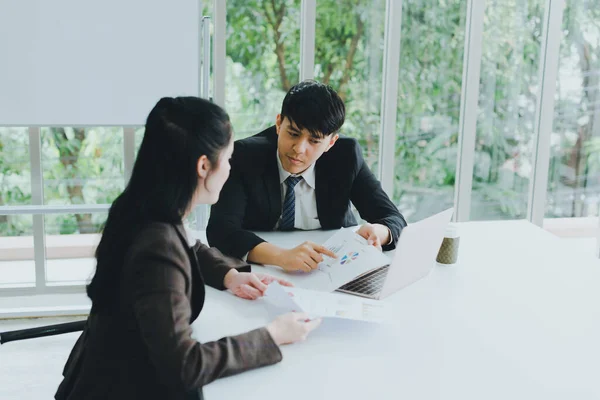 Asian Male Female Colleagues Discussing Work Graph Paper Notebook — Stock Photo, Image