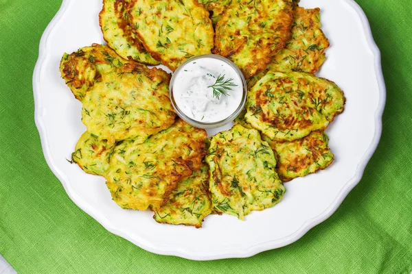 Zucchini Pancakes With  Sour Cream in White Plate. — Stock Photo, Image