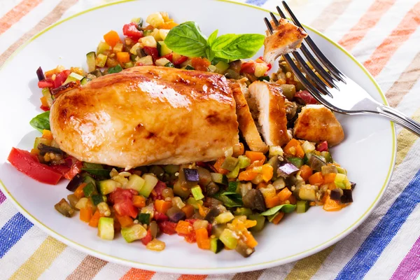 Fried chicken breast with sauteed vegetables: eggplant, carrot, zucchini, squash and tomatoes — Stock Photo, Image