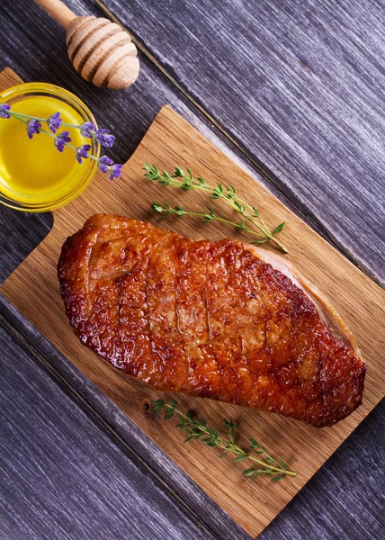 Duck breast, lavender honey and thyme, served on chopping board