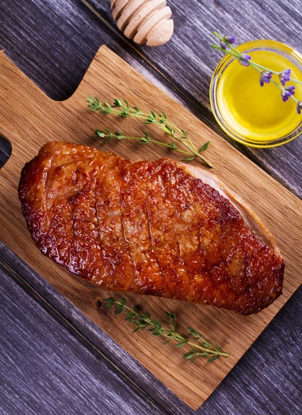 Duck breast, lavender honey and thyme, served on chopping board