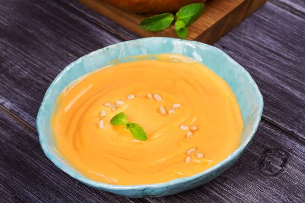 Bowl of pumpkin soup and  whole pumpkin. Butternut squash cream soup — Stock Photo, Image