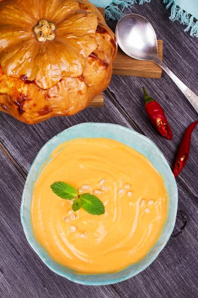 Bowl of pumpkin soup and  whole pumpkin. Butternut squash cream soup — Stock Photo, Image