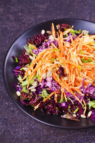 Red and white cabbage, carrot, lettuce, spring onion, nuts and seeds salad. Winter salad — Stock Photo, Image